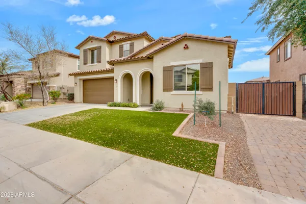 a front view of a house with a yard and garage