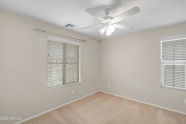 a view of an empty room with a ceiling fan
