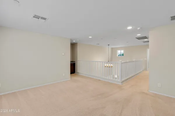 en empty room with windows and fan