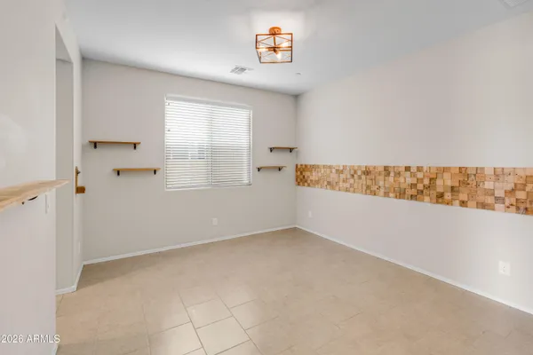 a large kitchen with granite countertop a sink a counter top space and cabinets