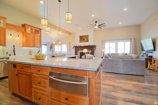 656 South Bullion Canyon Road Marysvale, UT 84750 - Photo 11 of 57 Kitchen with light stone counters, a warming drawer, brown cabinetry, glass insert cabinets, and dark wood-style floors
