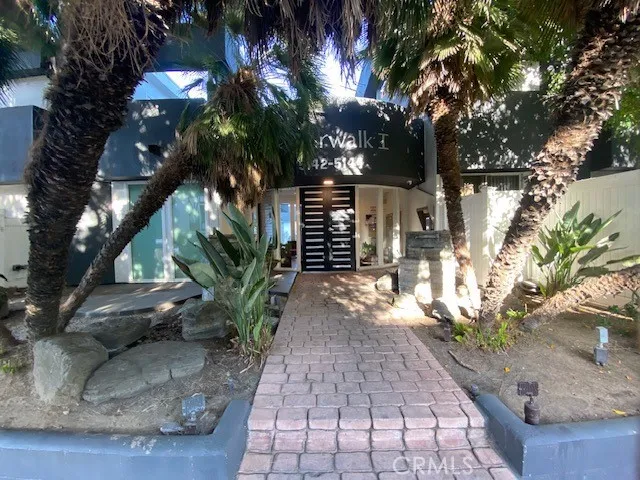 a view of a yard with plants and trees