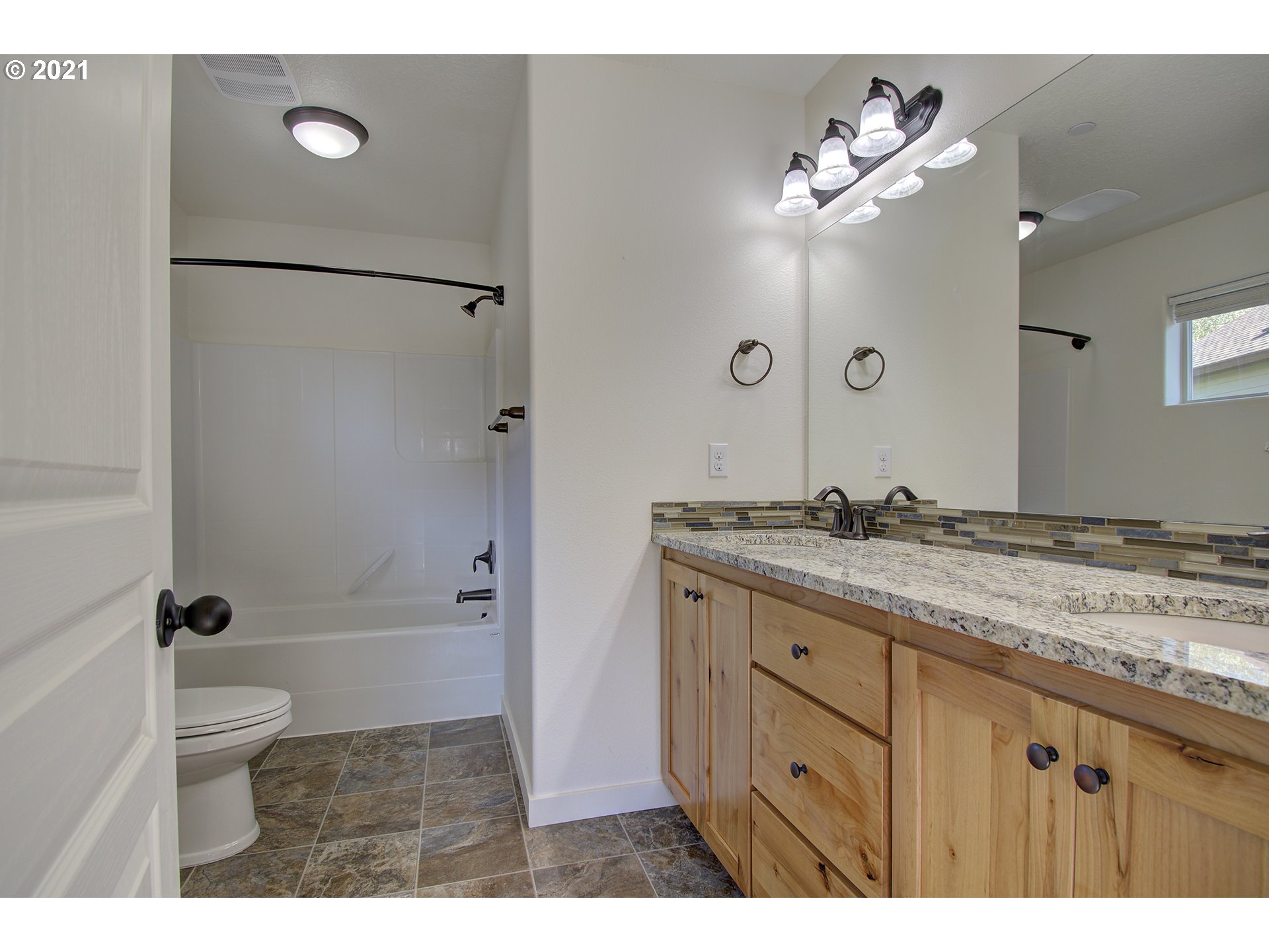 162 North 41st Place Ridgefield, WA 98642 - Photo 20 of 29 a bathroom with a granite countertop sink a toilet a shower and a mirror