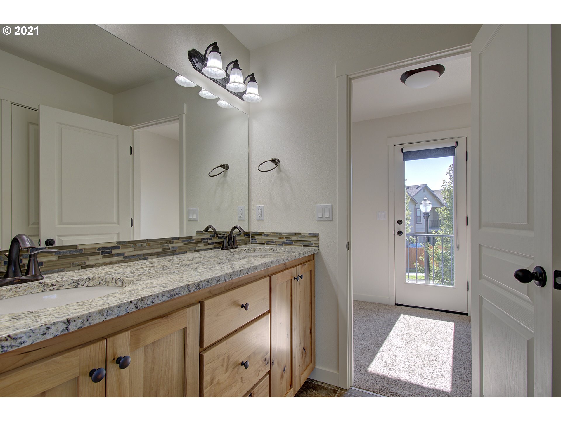 162 North 41st Place Ridgefield, WA 98642 - Photo 21 of 29 a bathroom with a granite countertop sink a light fixture and a mirror