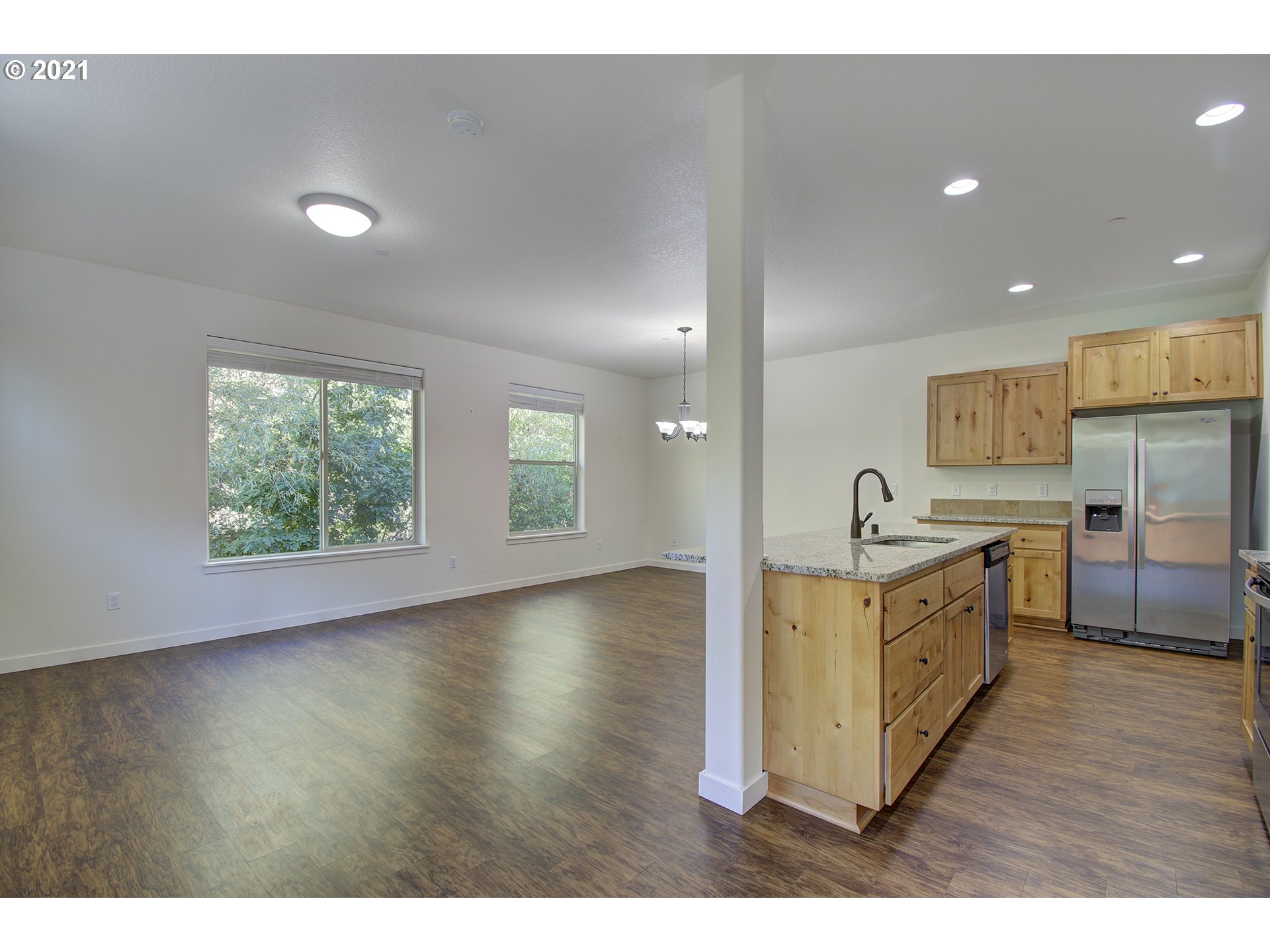 162 North 41st Place Ridgefield, WA 98642 - Photo 5 of 29 a kitchen with stainless steel appliances a sink cabinets and wooden floor