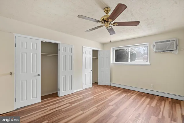 a view of a livingroom with wooden floor and closet area