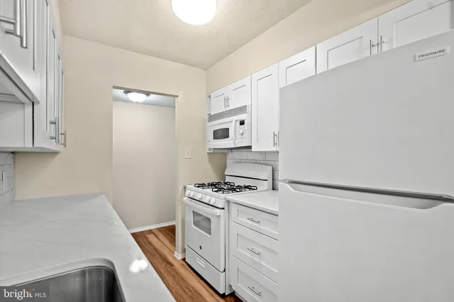 a view of a room with wooden floor and windows