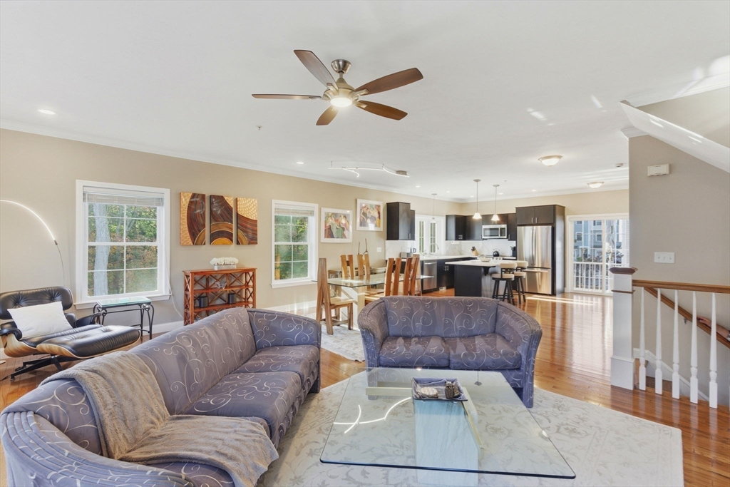 66 Compass Point, Unit 66 North Andover, MA 01845 - Photo 25 of 42 a living room with furniture kitchen view and a large window