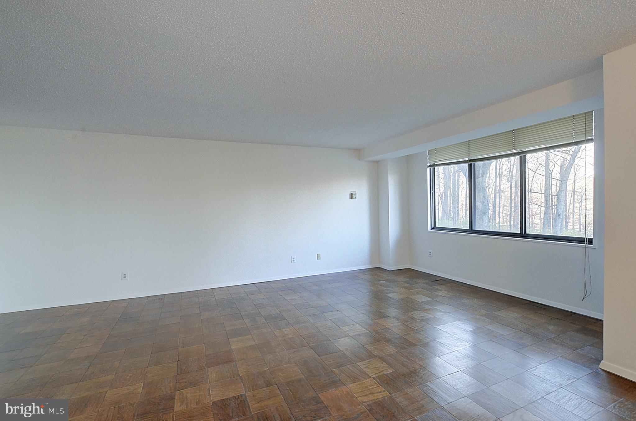 5225 Pooks Hill Road, Unit 324N Bethesda, MD 20814 - Photo 2 of 34 an empty room with wooden floor and windows