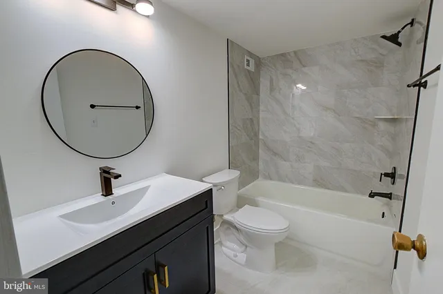 a bathroom with a sink a toilet and a mirror