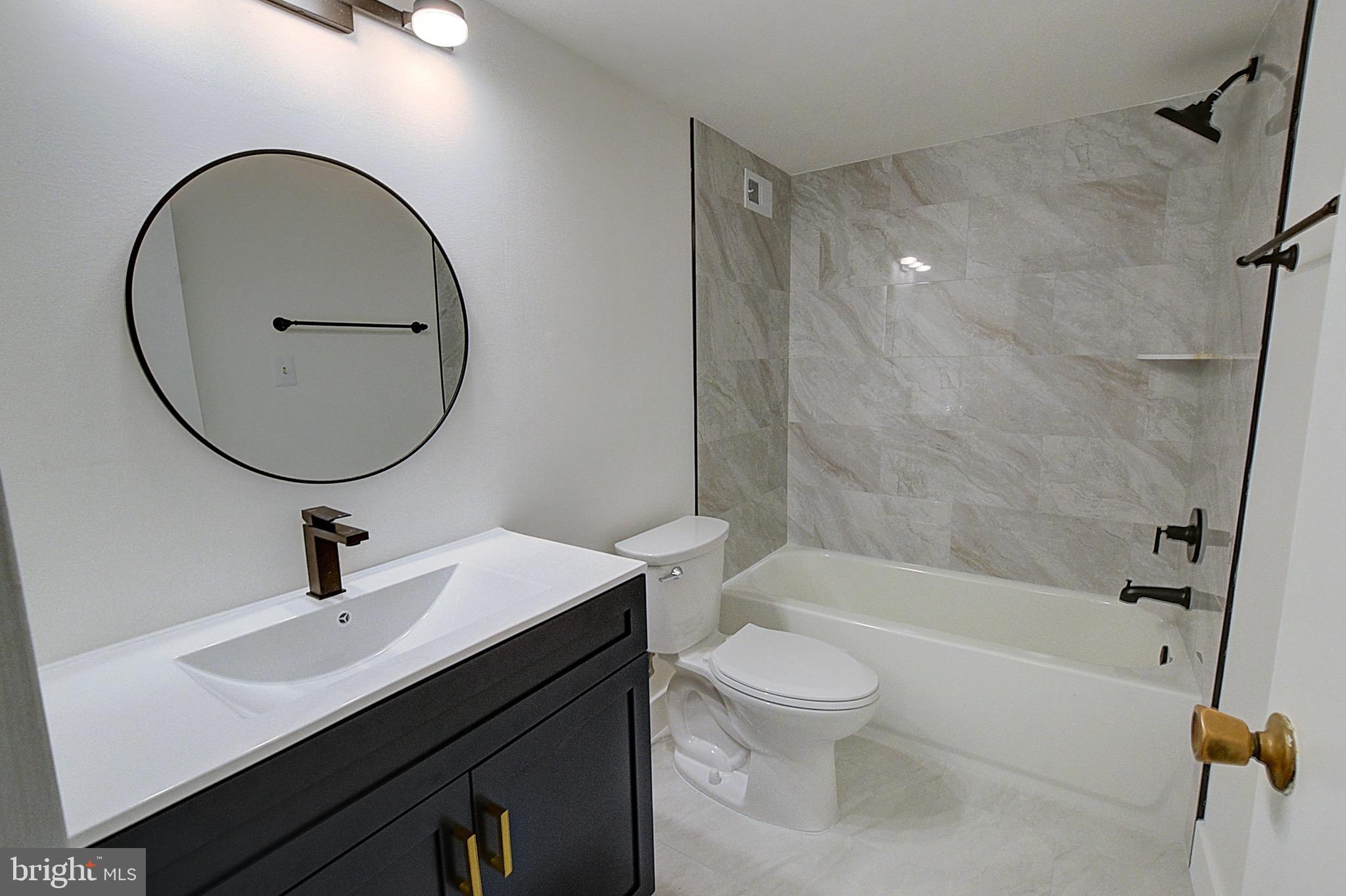 5225 Pooks Hill Road, Unit 324N Bethesda, MD 20814 - Photo 8 of 34 a bathroom with a sink a toilet and a mirror