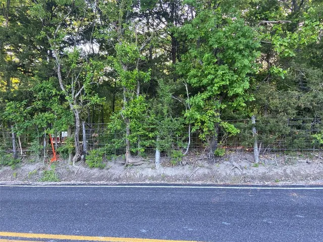 a backyard of a house with lots of trees