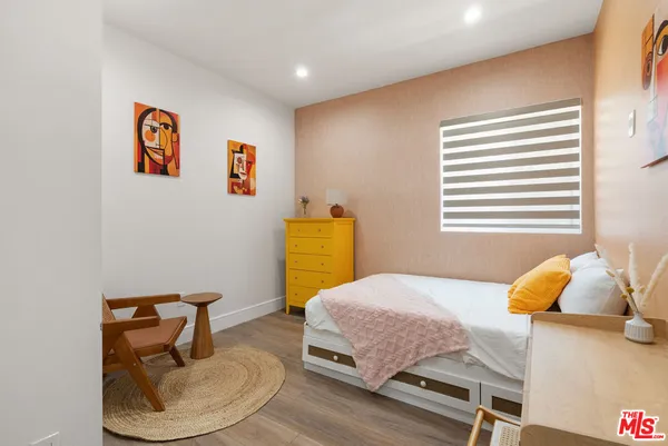 a bedroom with a bed and a table in it