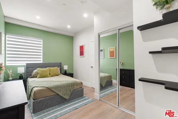 a bedroom with a bed and a couch