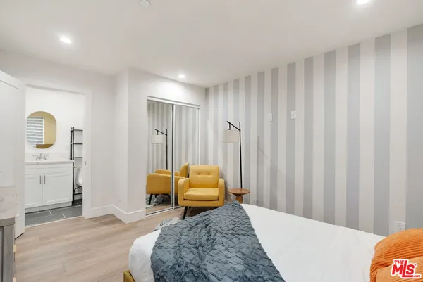 a bedroom with furniture and a chair