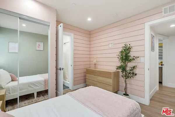 a bed room with a bed and a plant