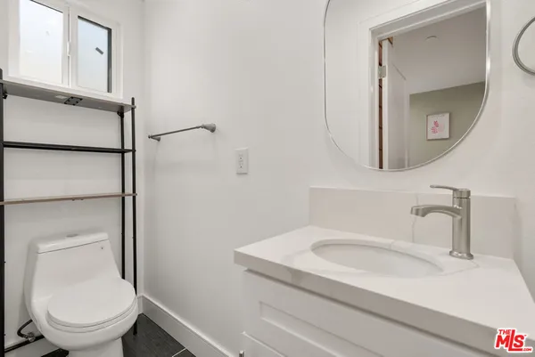 a bedroom with a bed and a potted plant