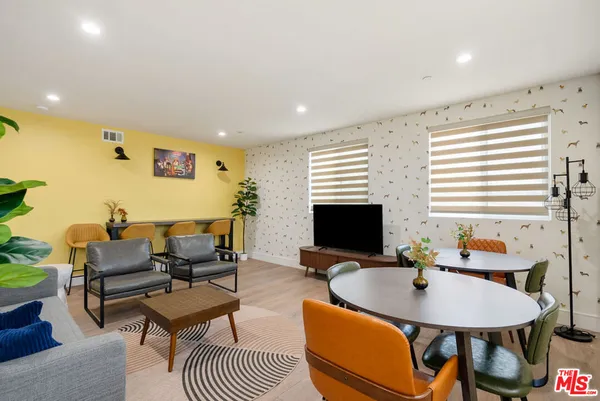 a living room with furniture potted plant and a window