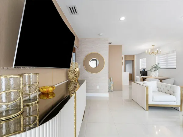 a kitchen with stainless steel appliances kitchen island granite countertop a refrigerator a stove and a sink