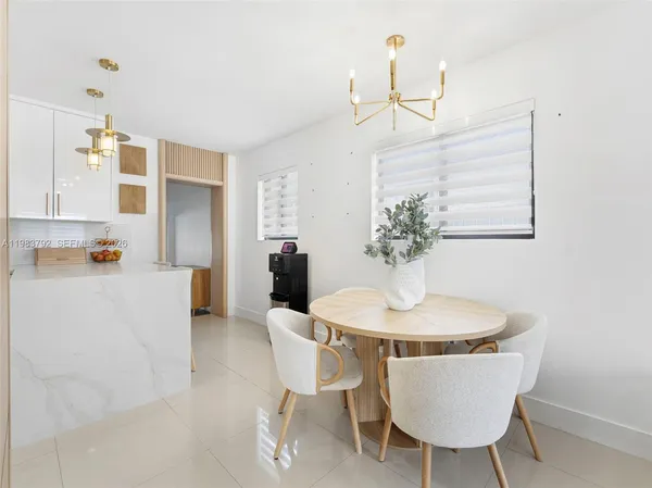 a kitchen with granite countertop white cabinets and stainless steel appliances