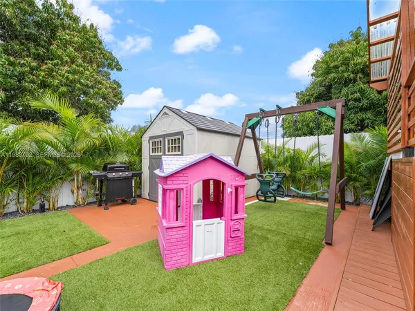 a backyard of a house with table and chairs
