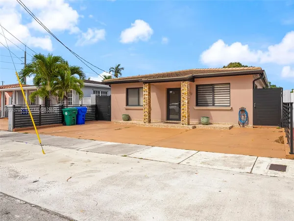 a view of a house with a backyard and a garage