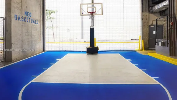 a room with wooden floor and windows