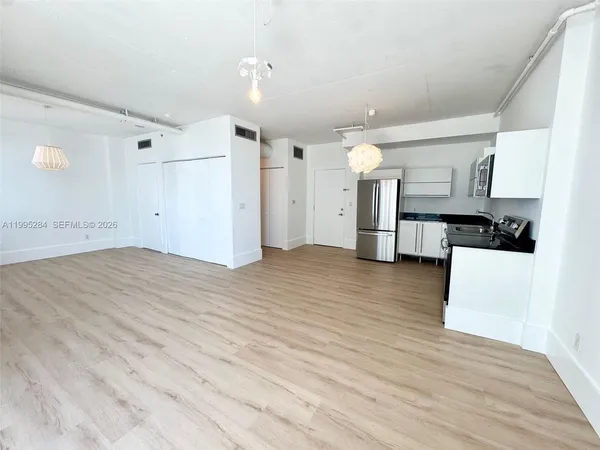 a view of a kitchen with wooden floor