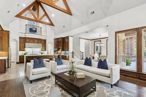 a living room with furniture a table and a large window