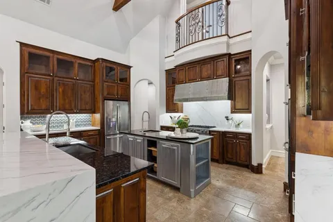 a kitchen with stainless steel appliances granite countertop a stove and a refrigerator