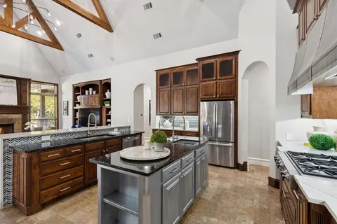 a kitchen with stainless steel appliances granite countertop a sink stove and refrigerator
