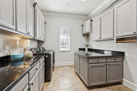 a kitchen with stainless steel appliances granite countertop a sink and a stove