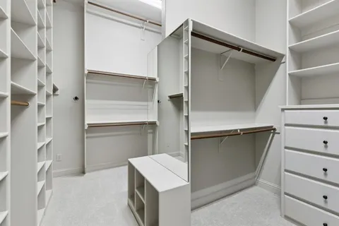 a kitchen with cabinets and a refrigerator