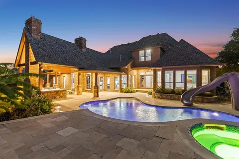 a view of a house with swimming pool and sitting area