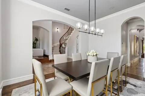 a view of a dining room with furniture and chandelier
