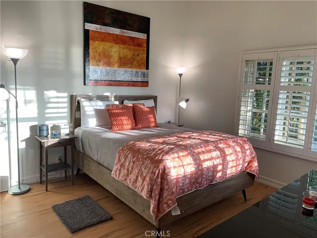 a bed sitting in a bedroom next to a window