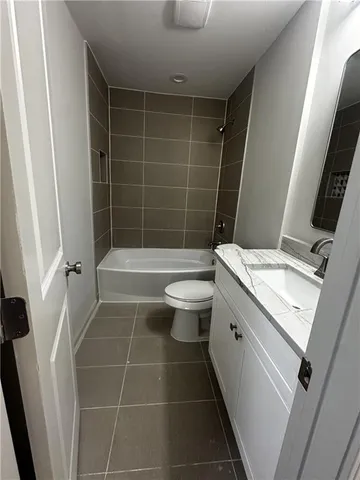 a bathroom with a toilet a sink and shower