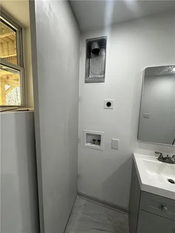 a bathroom with a sink a mirror and shower