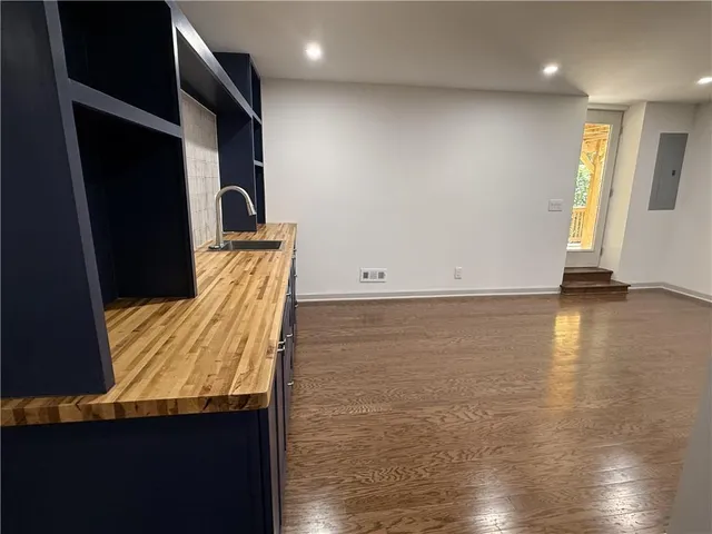 a view of room with wooden floor