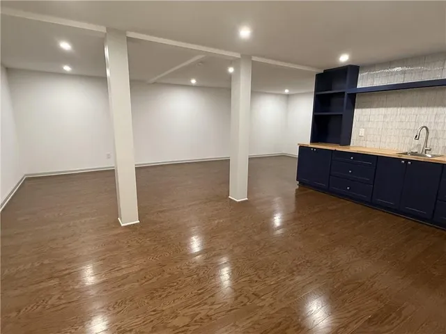 a view of a kitchen with a sink and a stove top oven