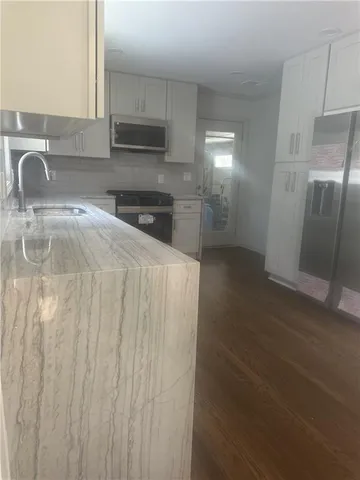 a kitchen with a sink and refrigerator