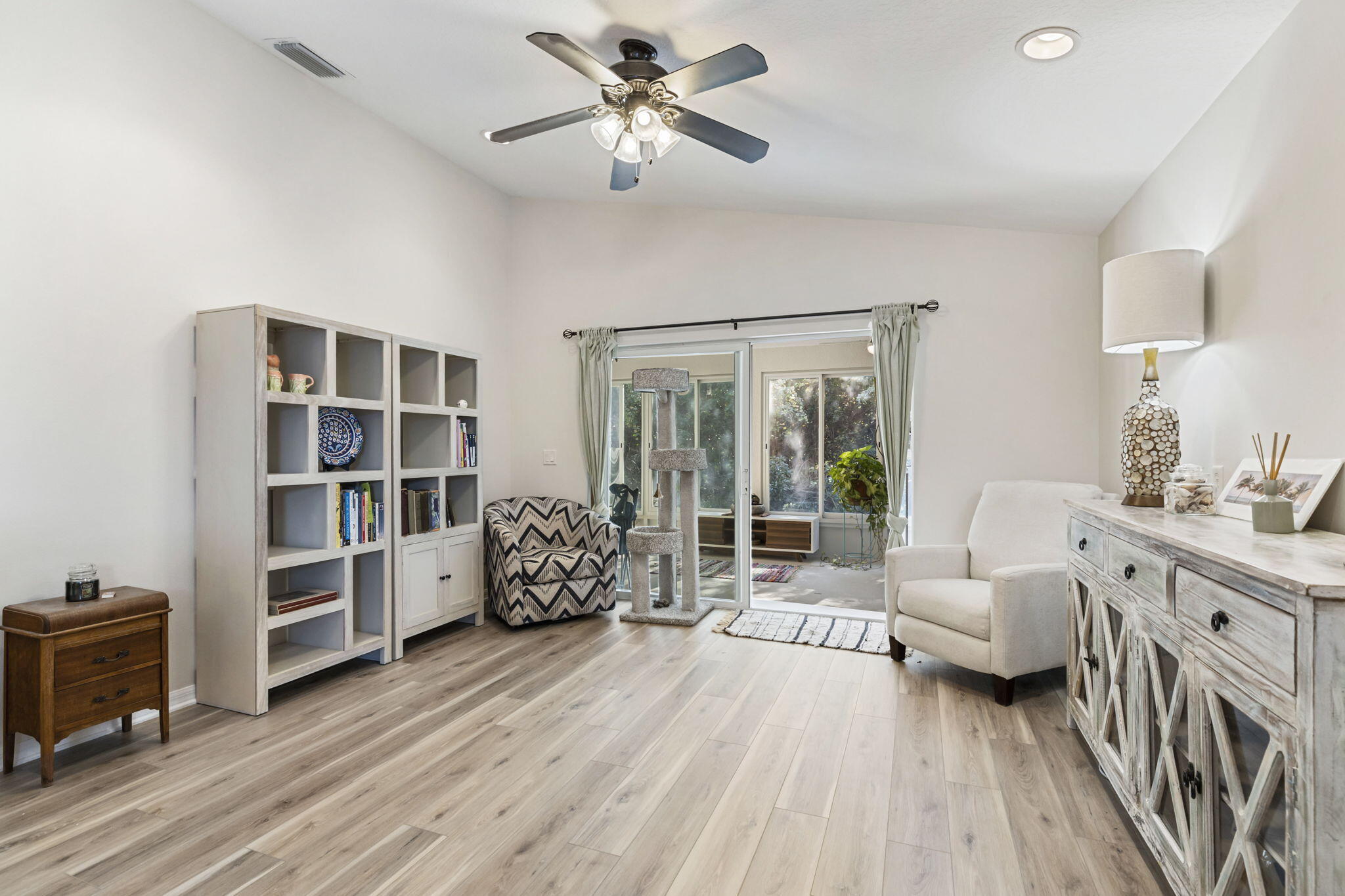 2140 Spring Creek Circle Palm Bay, FL 32905 - Photo 11 of 32 a living room with furniture and a book shelf