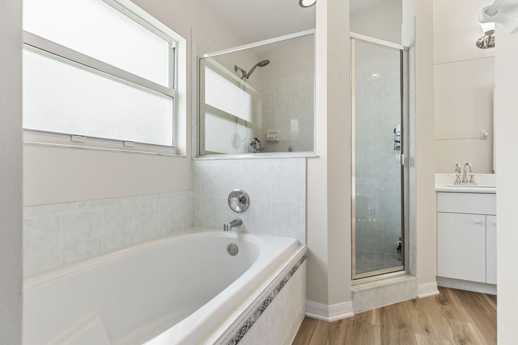 2140 Spring Creek Circle Palm Bay, FL 32905 - Photo 18 of 32 a bathroom with a tub a sink and a large mirror