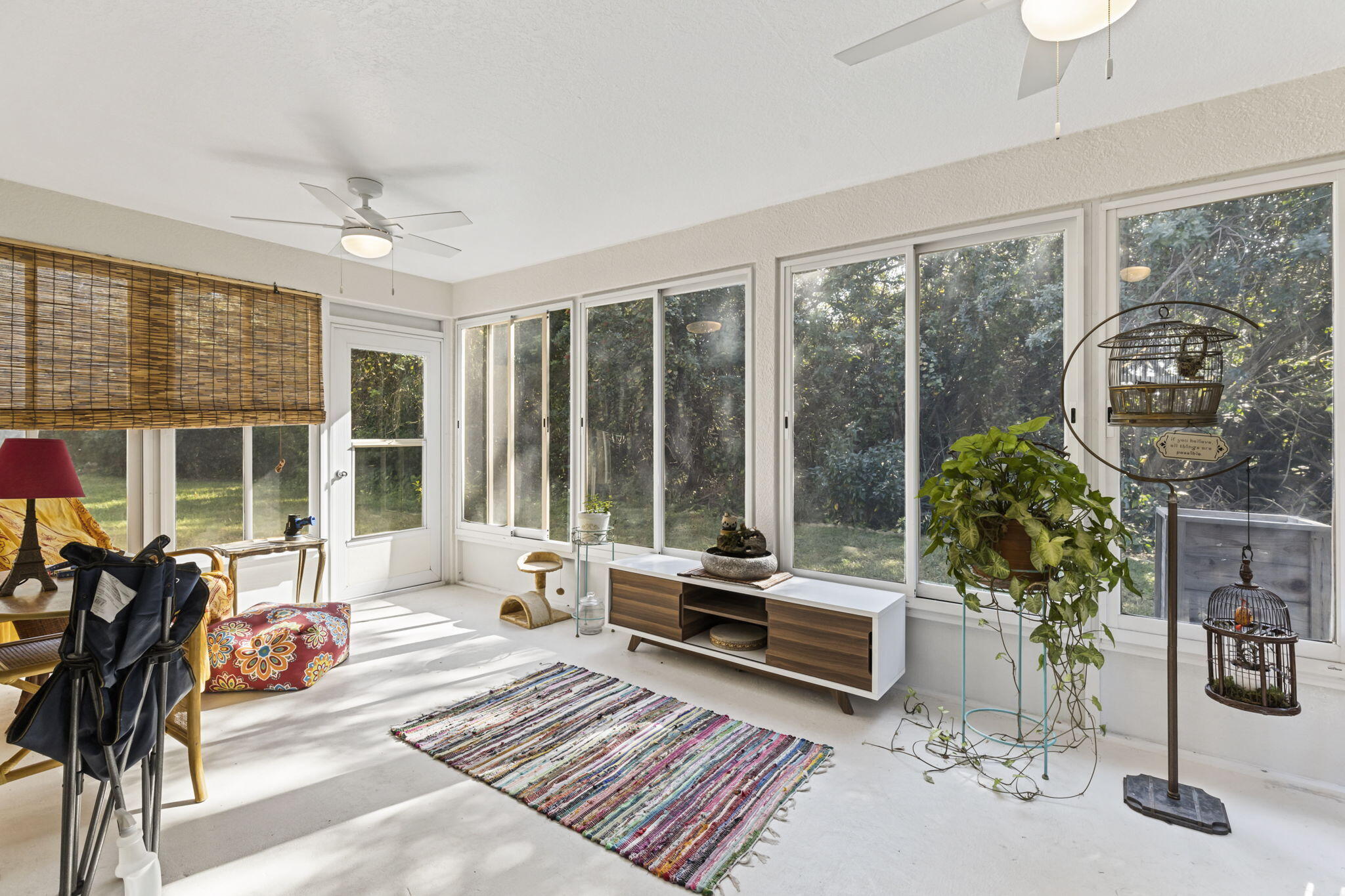 2140 Spring Creek Circle Palm Bay, FL 32905 - Photo 2 of 32 a living room with furniture and a floor to ceiling window