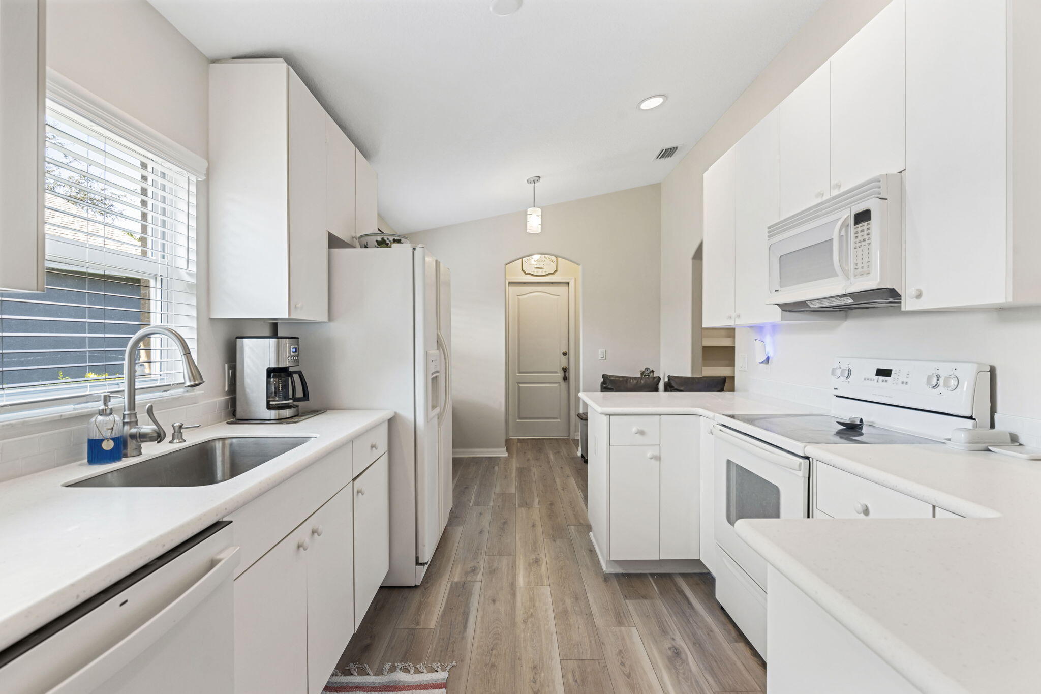 2140 Spring Creek Circle Palm Bay, FL 32905 - Photo 3 of 32 a kitchen with white cabinets appliances and sink