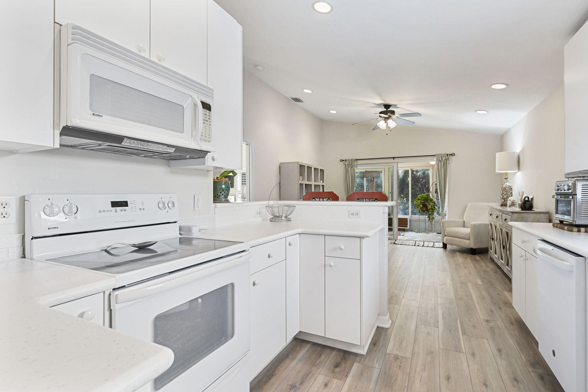 2140 Spring Creek Circle Palm Bay, FL 32905 - Photo 5 of 32 a kitchen with white cabinets and white appliances