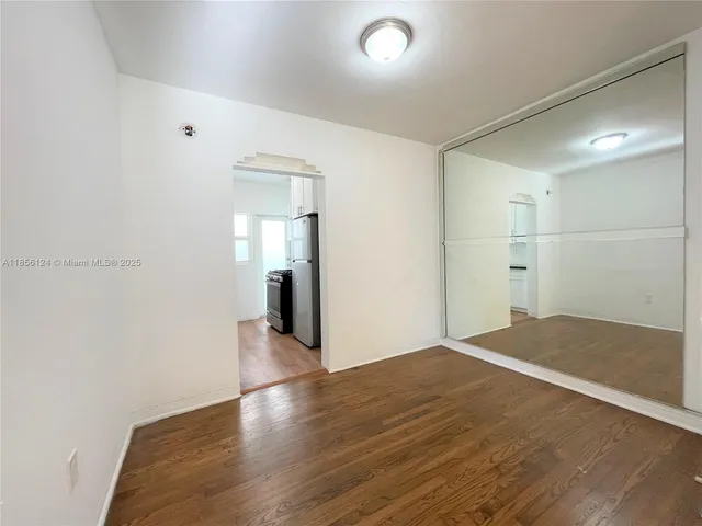 a view of livingroom and hallway with wooden floor
