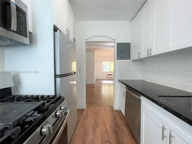 a kitchen with a stove and a refrigerator