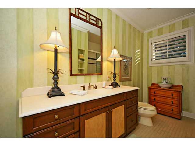 23 West High Point Road Sewall's Point, FL 34996 - Photo 14 of 25 a bathroom with a sink a toilet and a mirror