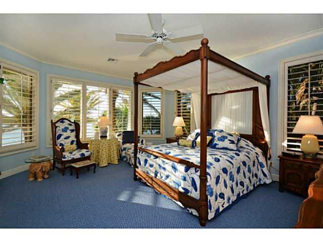 23 West High Point Road Sewall's Point, FL 34996 - Photo 15 of 25 a bedroom with bed and glass windows
